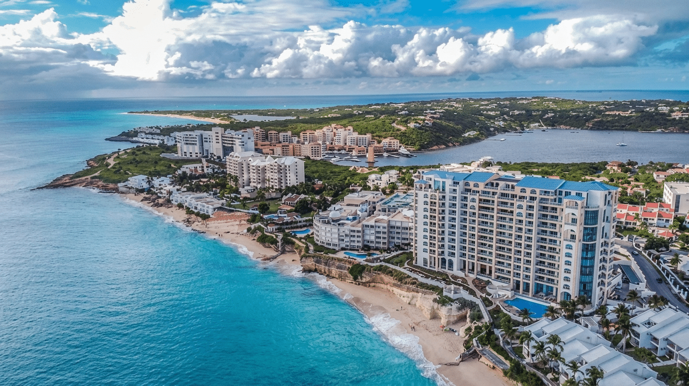 Aerial view of a tropical coastline with high-rise hotels along a sandy beach and turquoise sea.