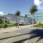 Modern campus plaza with a glass-walled building, palm trees, and a covered walkway; people walking on a sunny day.