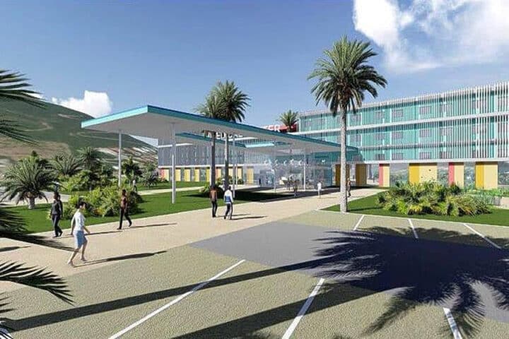 Modern campus plaza with a glass-walled building, palm trees, and a covered walkway; people walking on a sunny day.